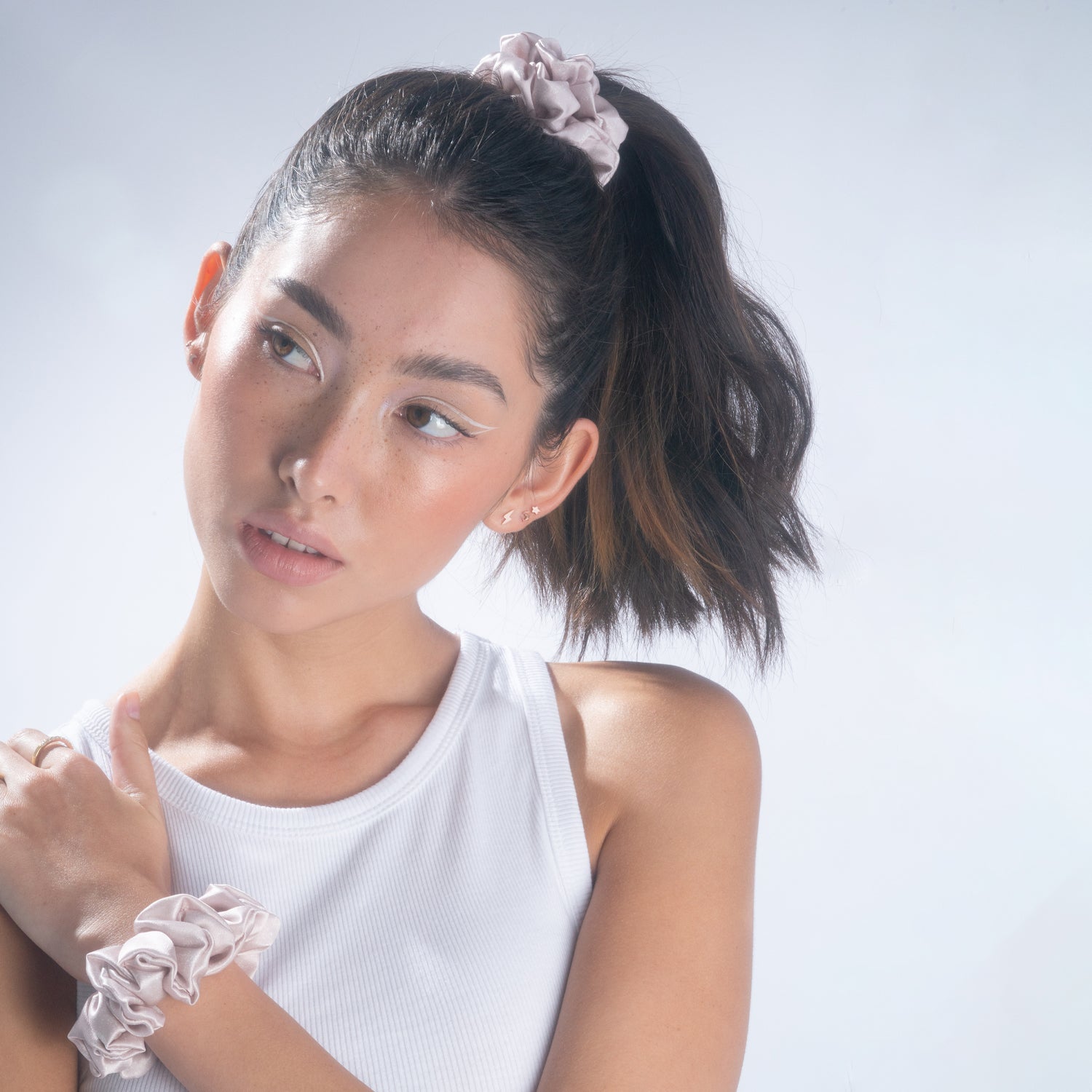 A woman wearing a lilac silk scrunchie
