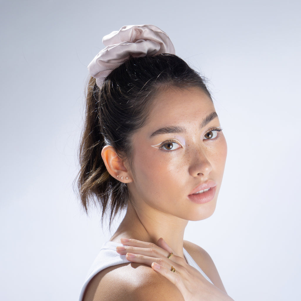A woman wearing a lilac jumbo silk scrunchie