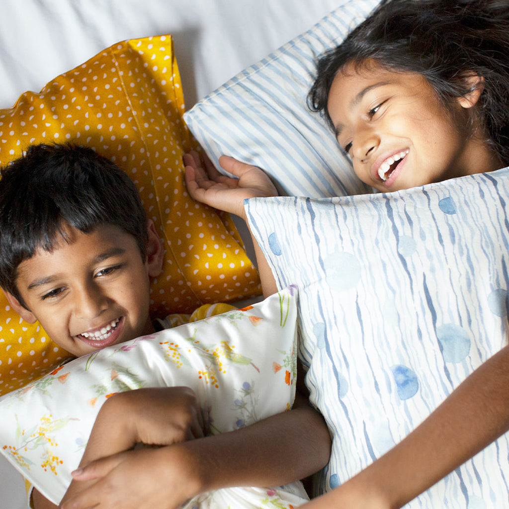 100% pure Mulberry silk pillowcases in 22 momme. Comes in four unique prints that are hypoallergenic and cooling. In mustard yellow, multi-colored floral print, cerulean blue wavy lines and vertical stripes.King, standard and toddler pillow sizes available.