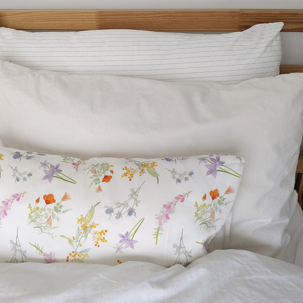 Mini floral silk pillowcase on a bed