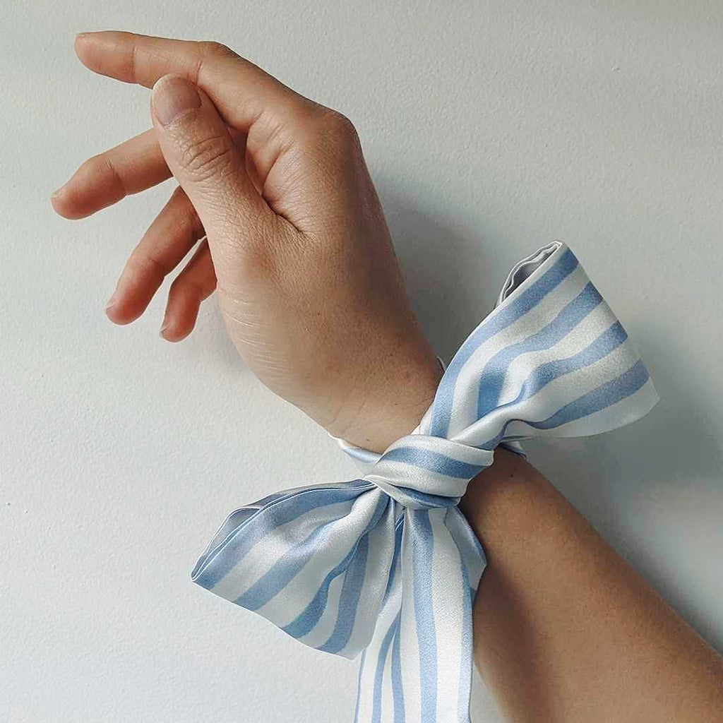 A silk ribbon tied around a woman's wrist